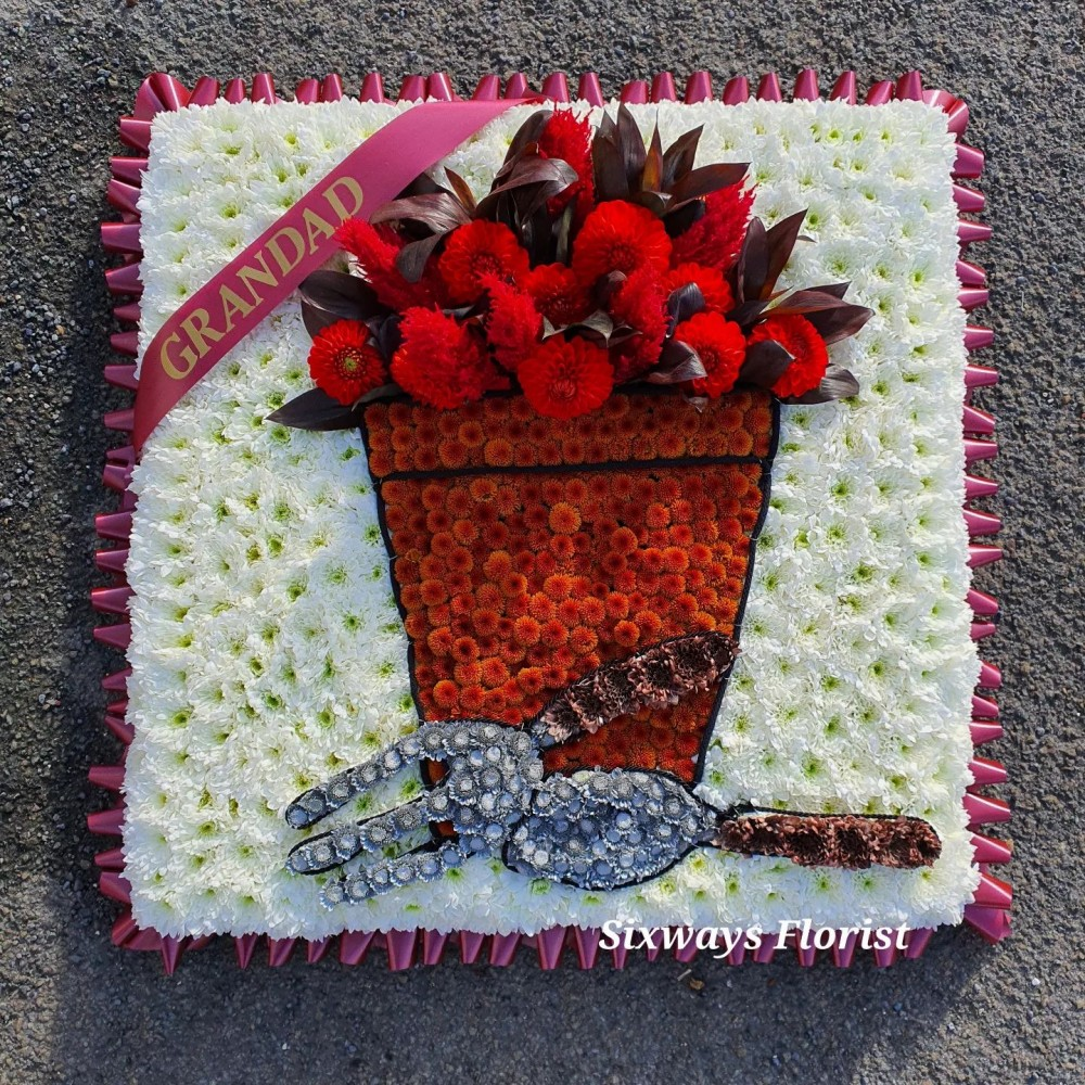 garden pot with fork and trowel